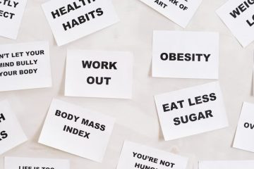 Collection of motivational quotes promoting health and wellness on paper cards.